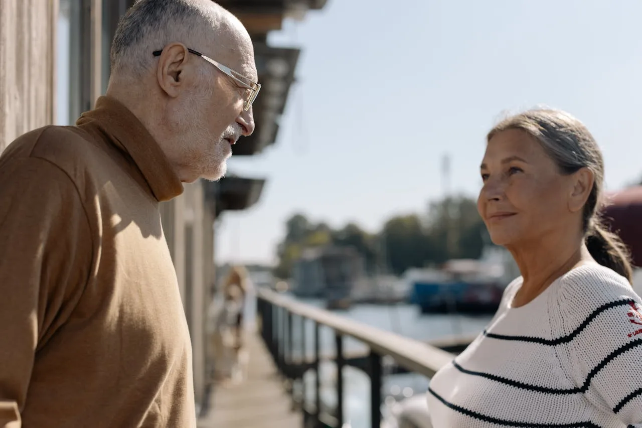 Happy senior couple smiling together, protected by final expense and burial insurance